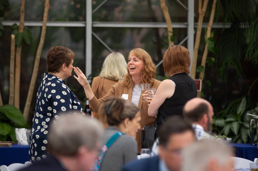 Lori Staggs chatting with two other colleagues